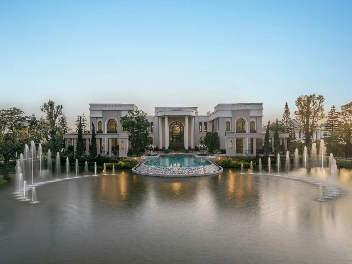 Grand luxury residential clubhouse reflected in a calm lake