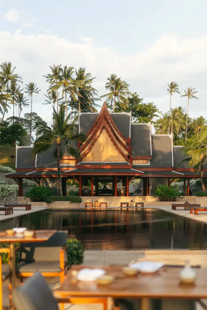 Thai-inspired luxury resort pavilion reflected in water